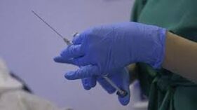 Syringe in the doctor's hand